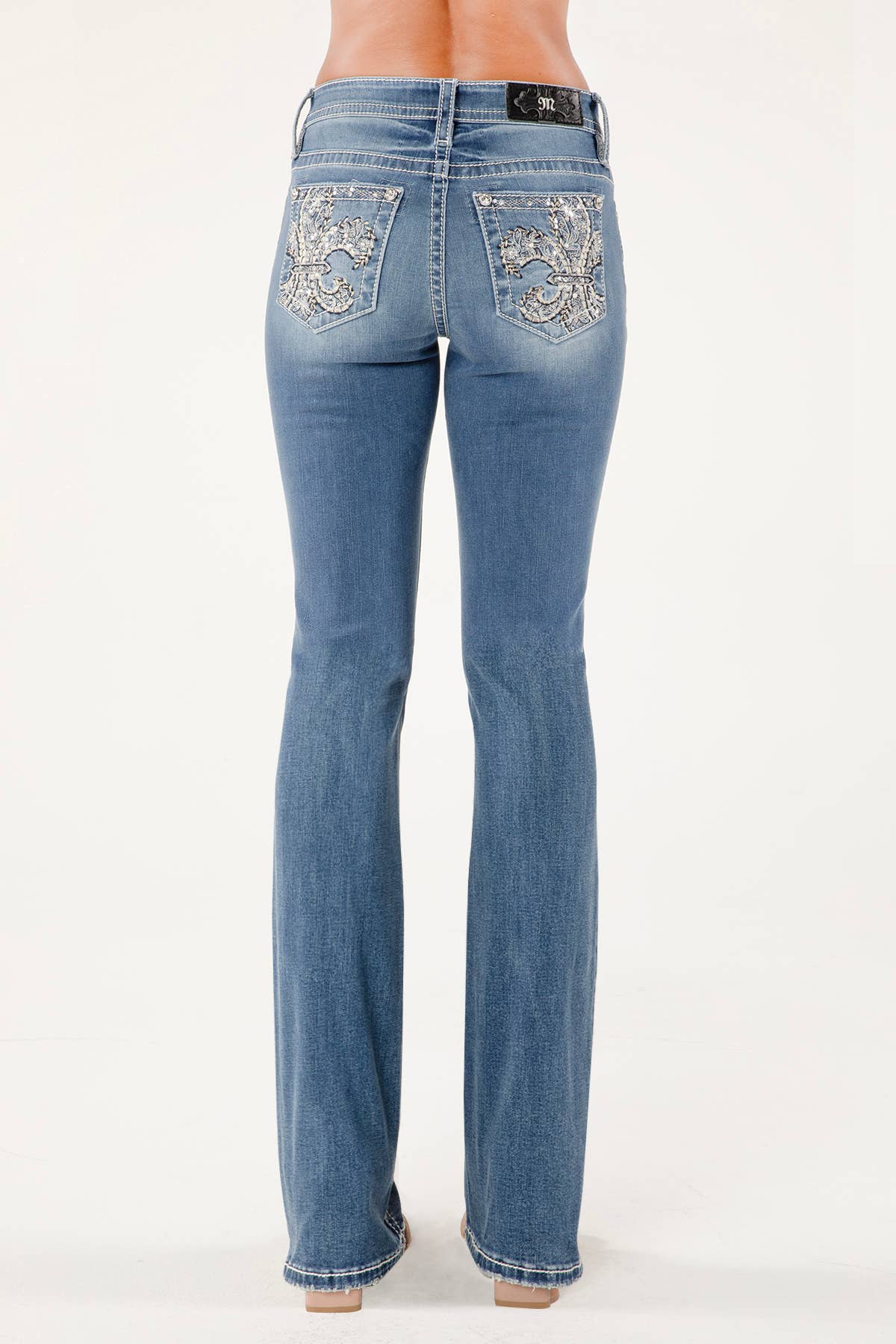 Miss Me mid-rise skinny jeans in dark wash with classic five-pocket design and fitted silhouette.
