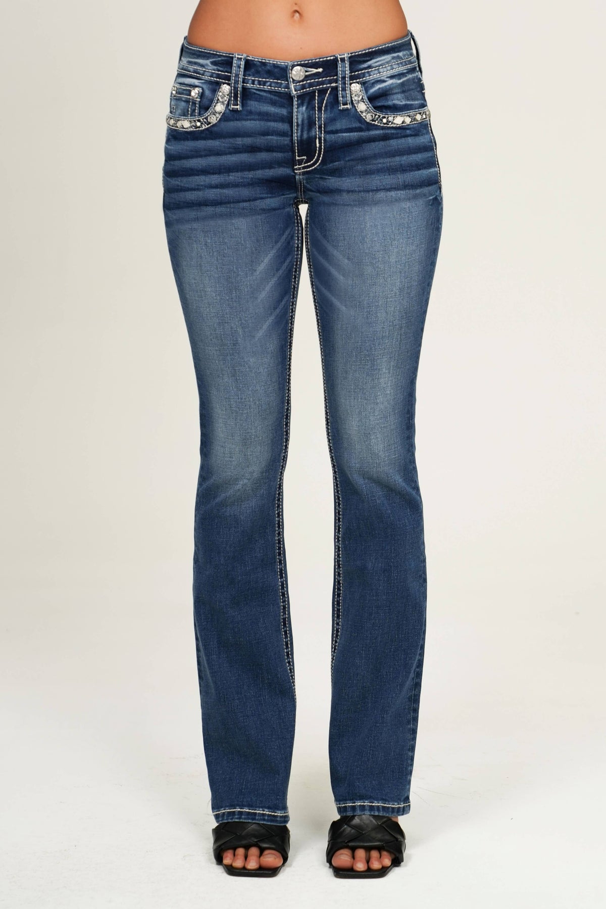 Miss Me 30 mid-rise boot cut jeans with distressed details and classic denim wash, featuring a stylish fit and signature embroidery.