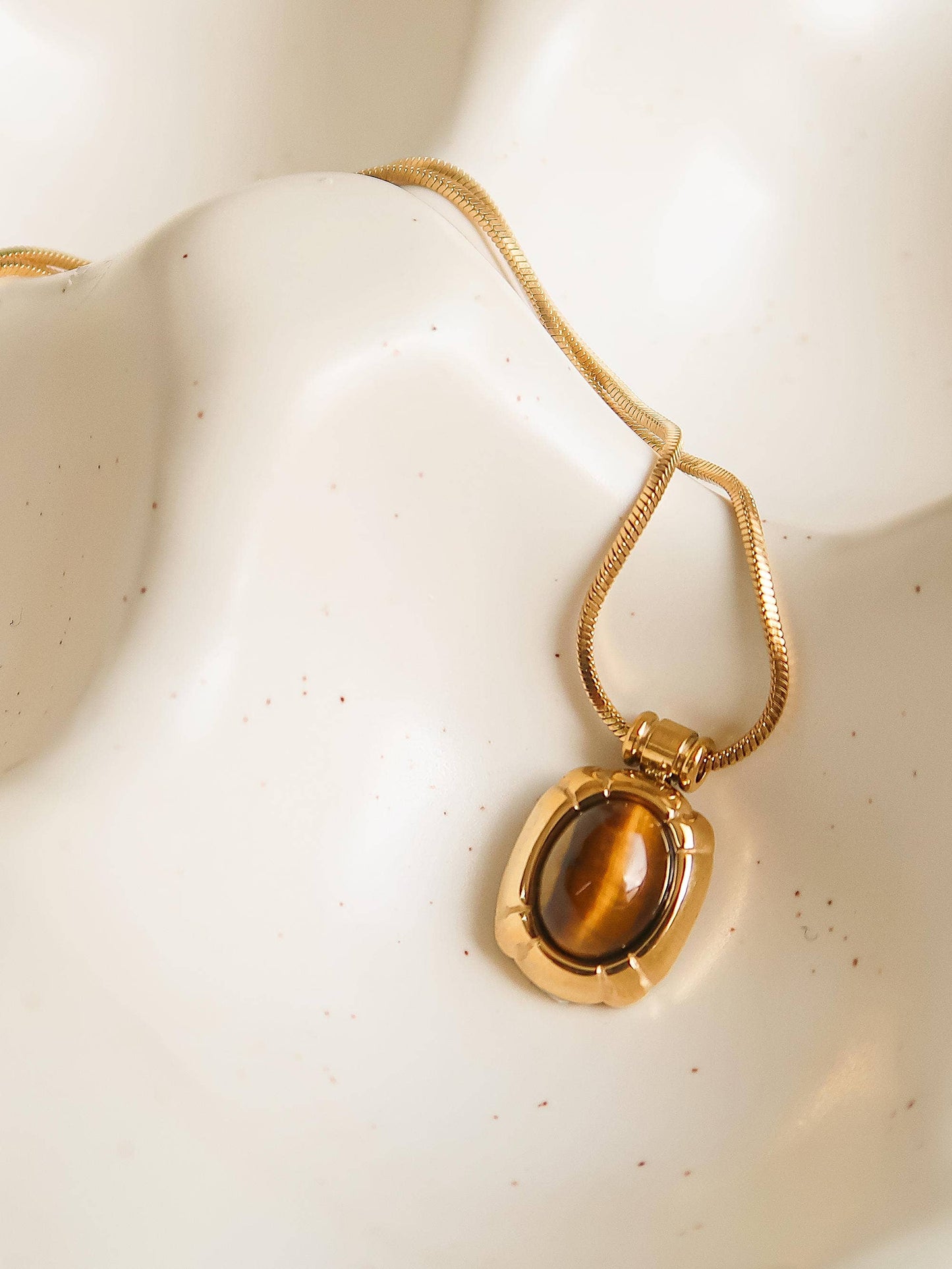 18K gold non-tarnish natural stone necklace featuring a pendant with a sleek design and vibrant stone, worn on a delicate chain.