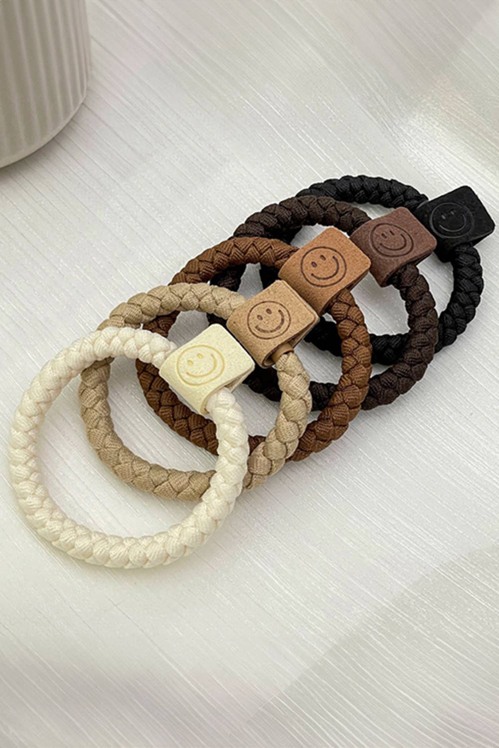 Five colorful smile face decor braided hair ties with playful design, ideal for kids and teens' hairstyles.