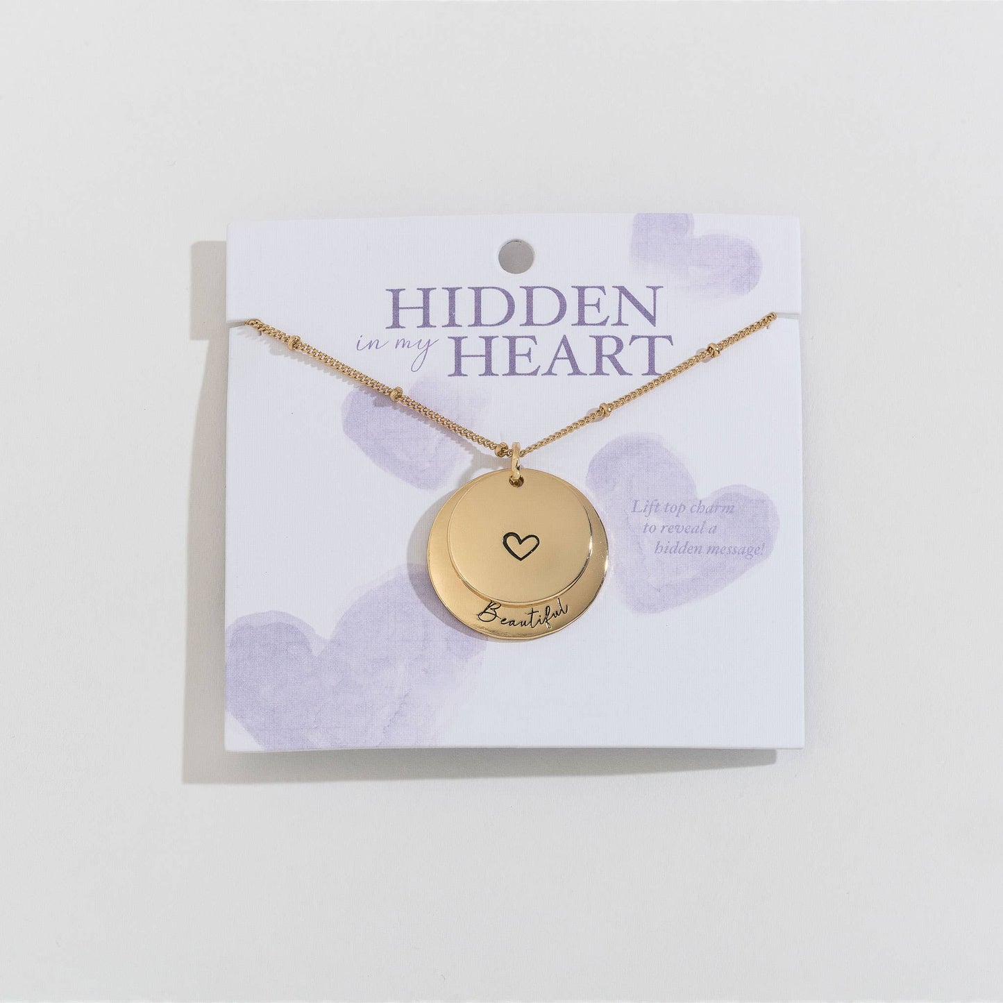 Hidden heart pendant necklace with delicate chain, showcasing a beautiful silver jewelry piece on a neutral background.