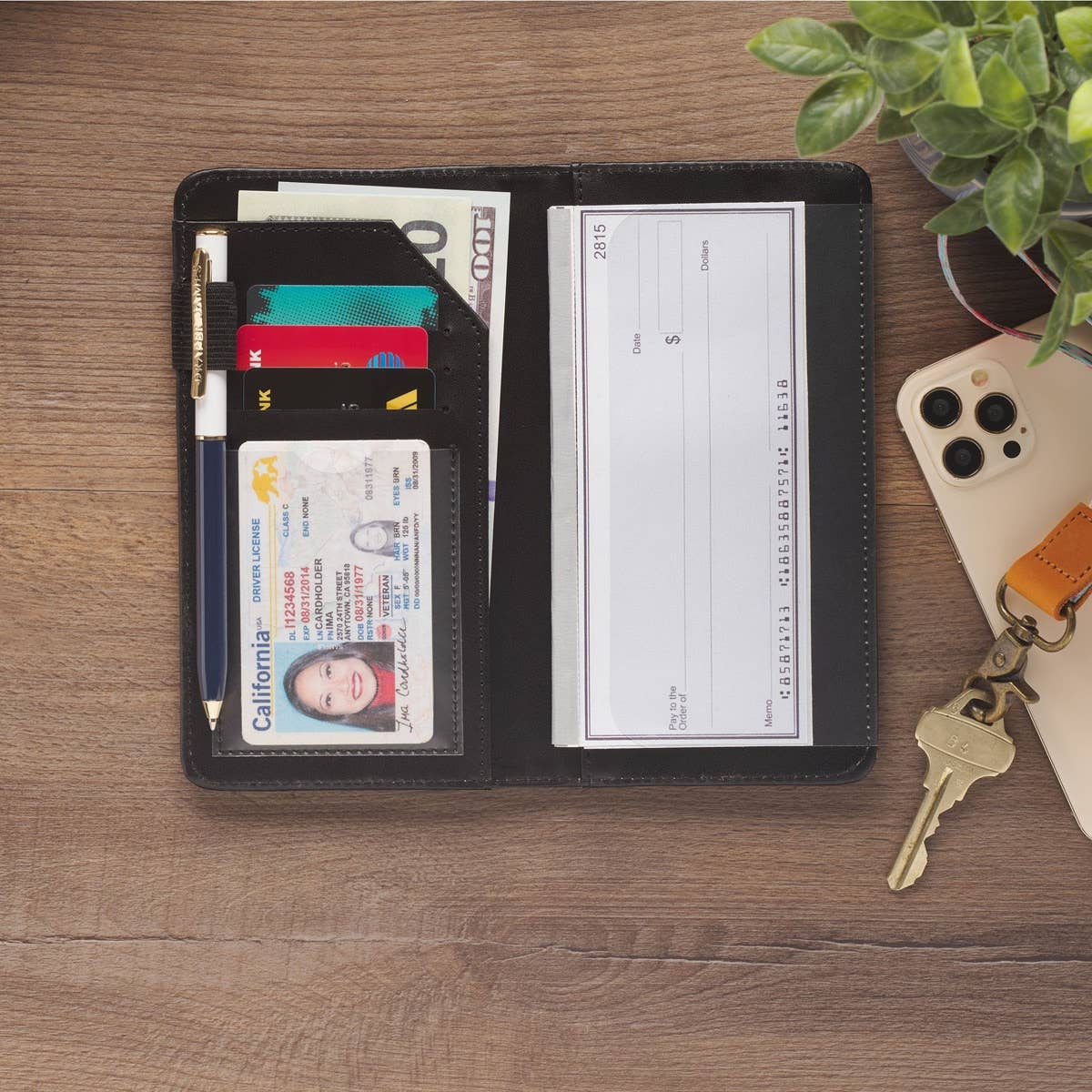Teal checkbook wallet with "Be Still Ps. 46:10" inscription, featuring card slots and a compact design for everyday organization.