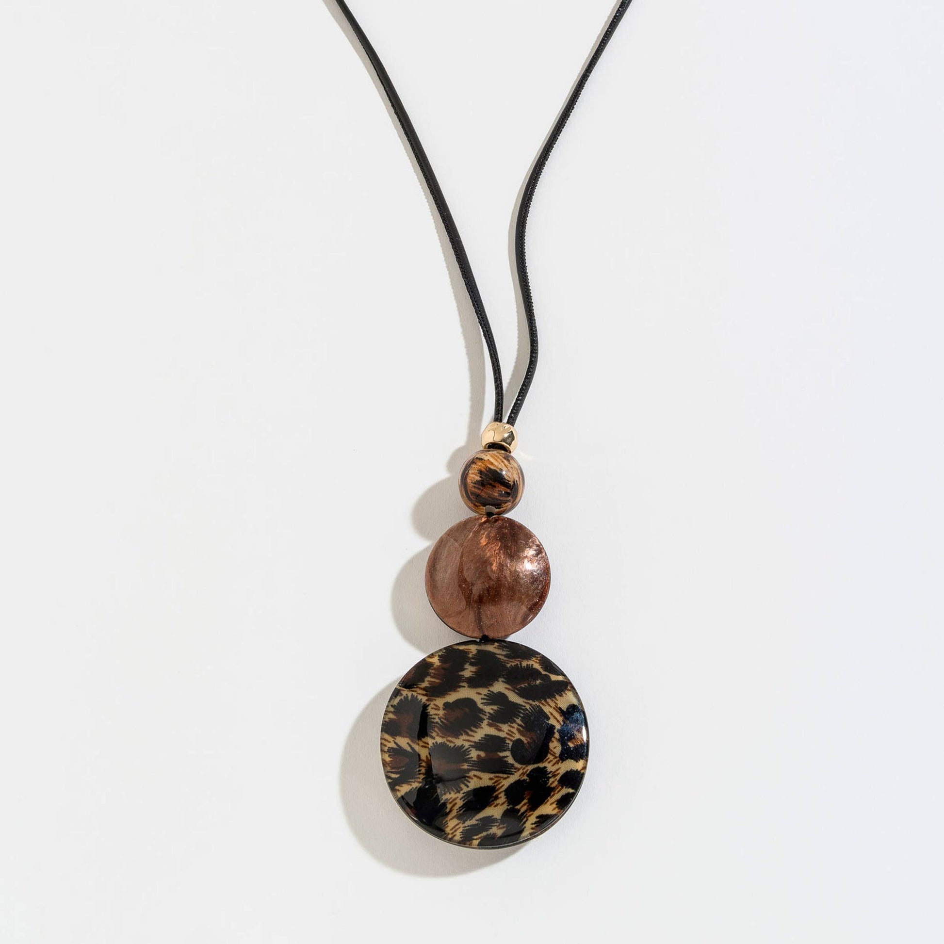 Cheetah print bubble disc and corded Y-neck necklace with gold-tone accents, featuring bold animal print design.