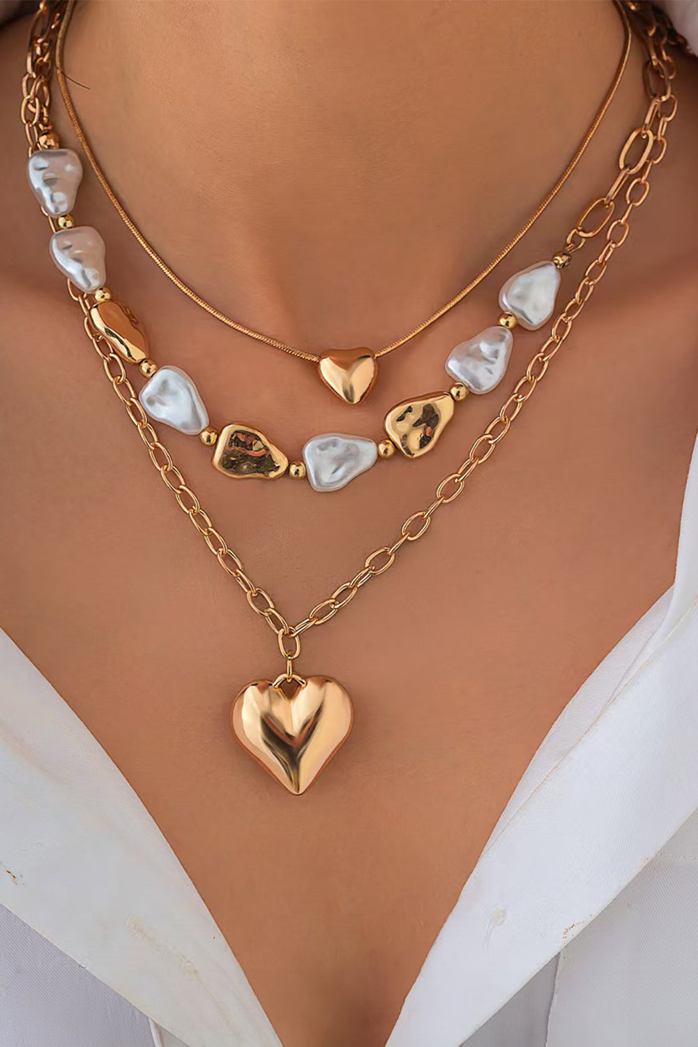 Gold heart-shaped fashion necklace with intricate design, featuring a delicate chain and elegant pendant.