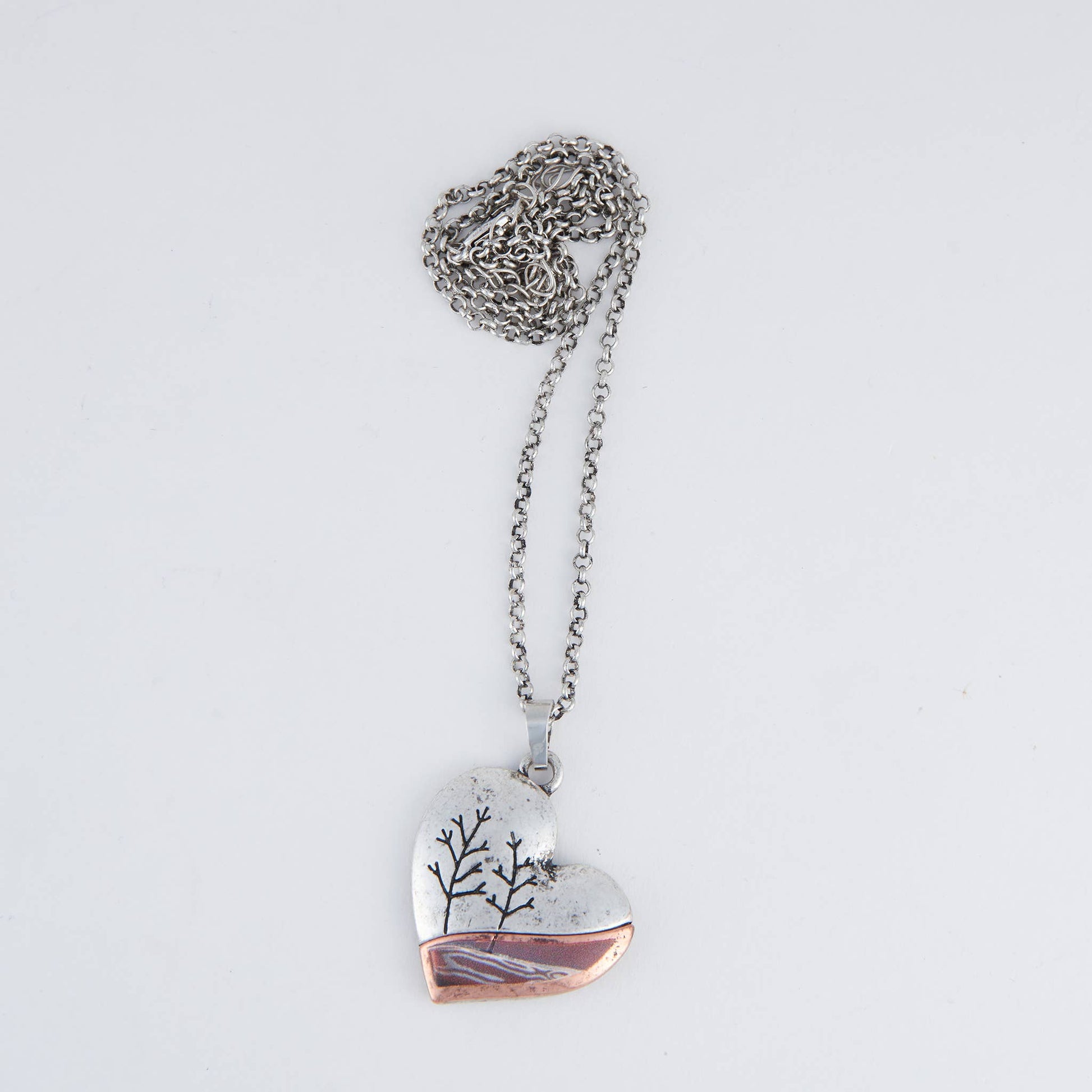 Kelso Nature Heart 16-inch pendant necklace featuring a heart-shaped pendant with natural wood and silver details.