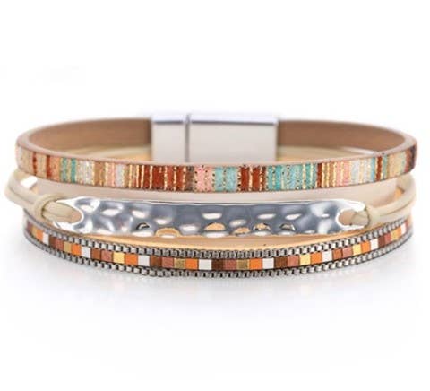 Tan leather strap with silver hammered bracelet, stylish jewelry accessory featuring textured metal and smooth leather details.