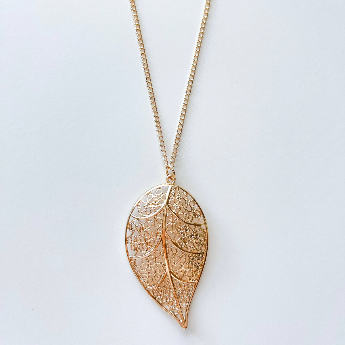 Long chain necklace featuring a stylish leaf pendant, perfect for fashion accessories and layered jewelry looks.