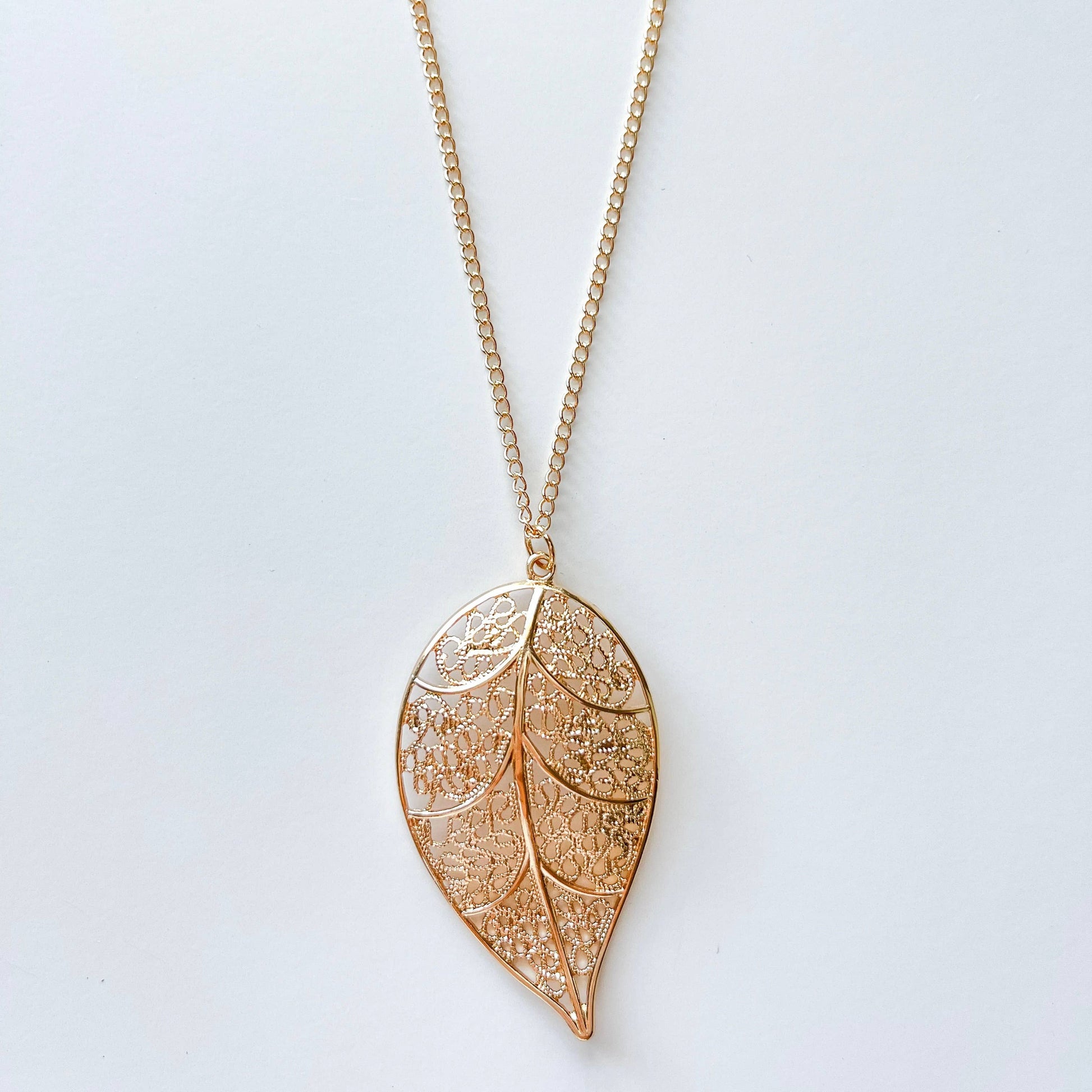 Long chain necklace featuring a stylish leaf pendant, perfect for fashion accessories and layered jewelry looks.