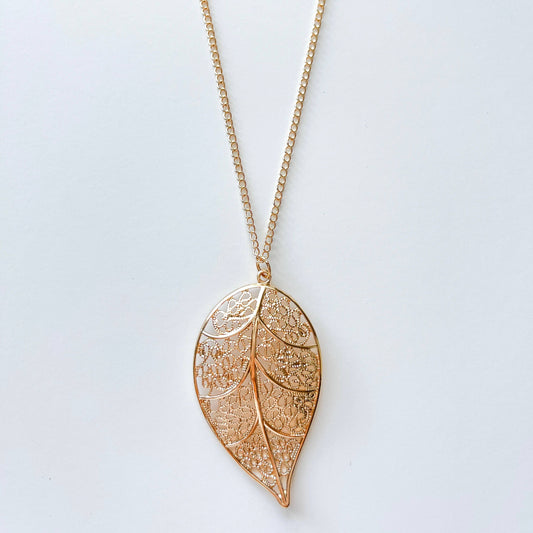 Long chain necklace featuring a stylish leaf pendant, perfect for fashion accessories and layered jewelry looks.