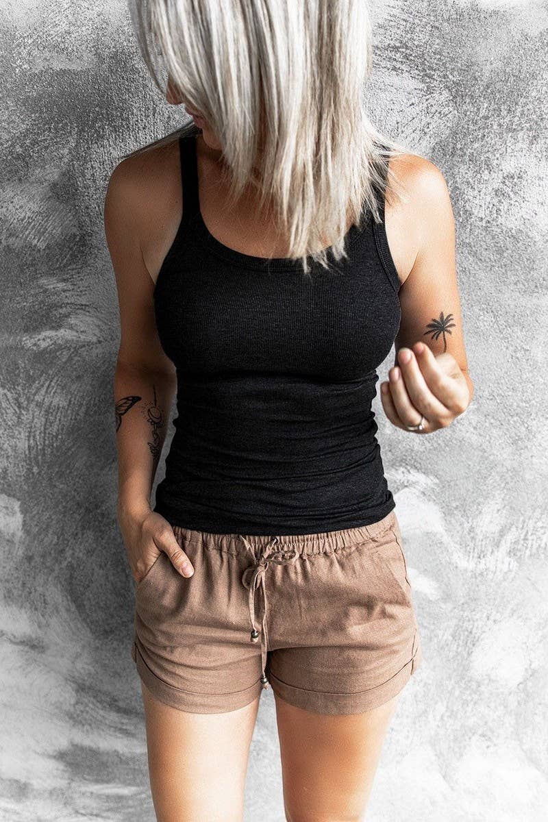 Ninexis round neck ribbed tank top displayed on a hanger, showcasing its fitted, textured fabric and classic sleeveless design.