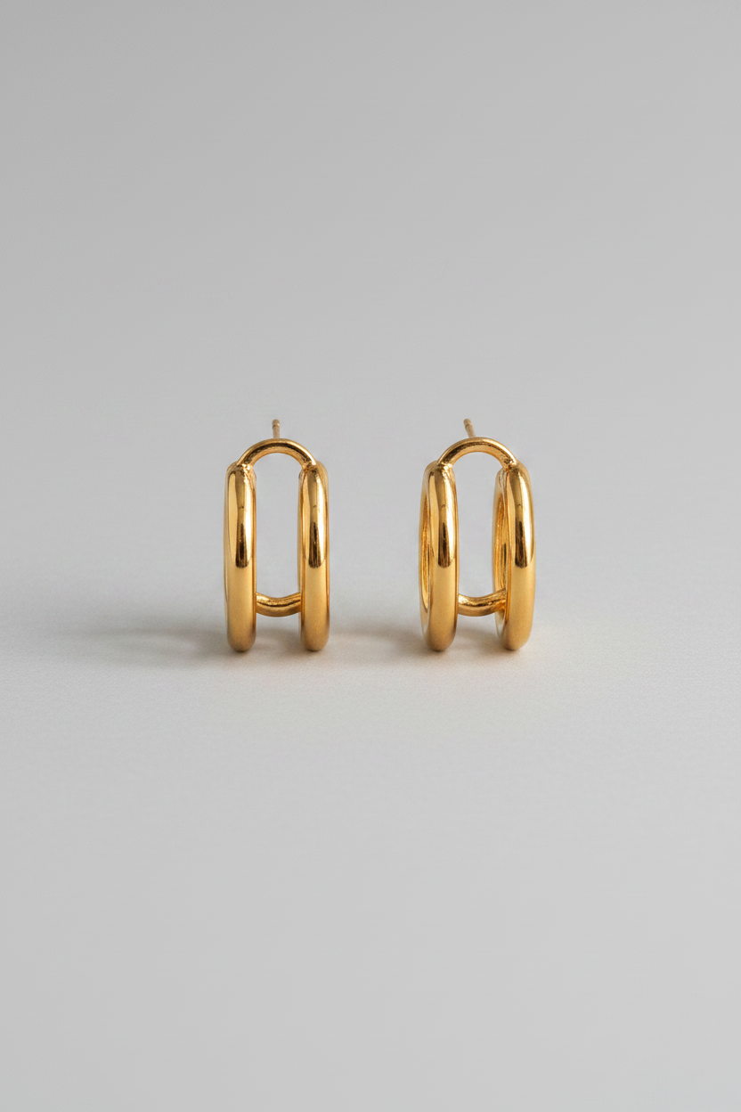 18K gold non-tarnish double C hoop earring by Flanerie by MAIQ, showing the shiny gold finish and double hoop design.