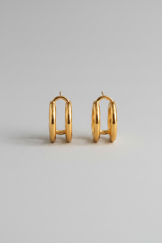 18K gold non-tarnish double C hoop earring by Flanerie by MAIQ, showing the shiny gold finish and double hoop design.