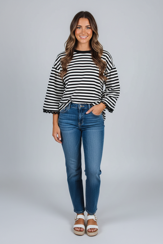 Black striped bell sleeve top by CSB Private Label showing a stylish long-sleeve shirt with bell cuffs and bold stripe pattern.