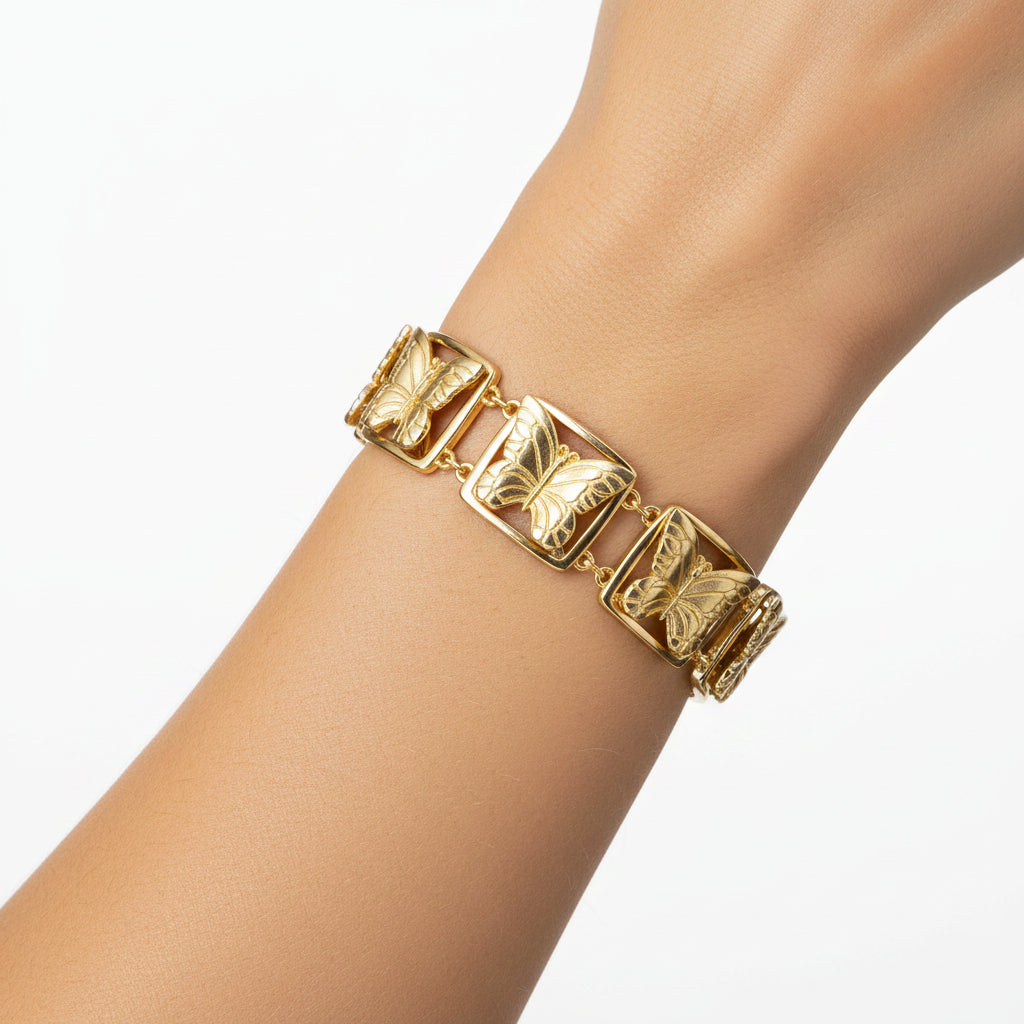 Matte gold butterfly link bracelet by Patricia Nash, featuring delicate butterfly charms on a stylish chain.