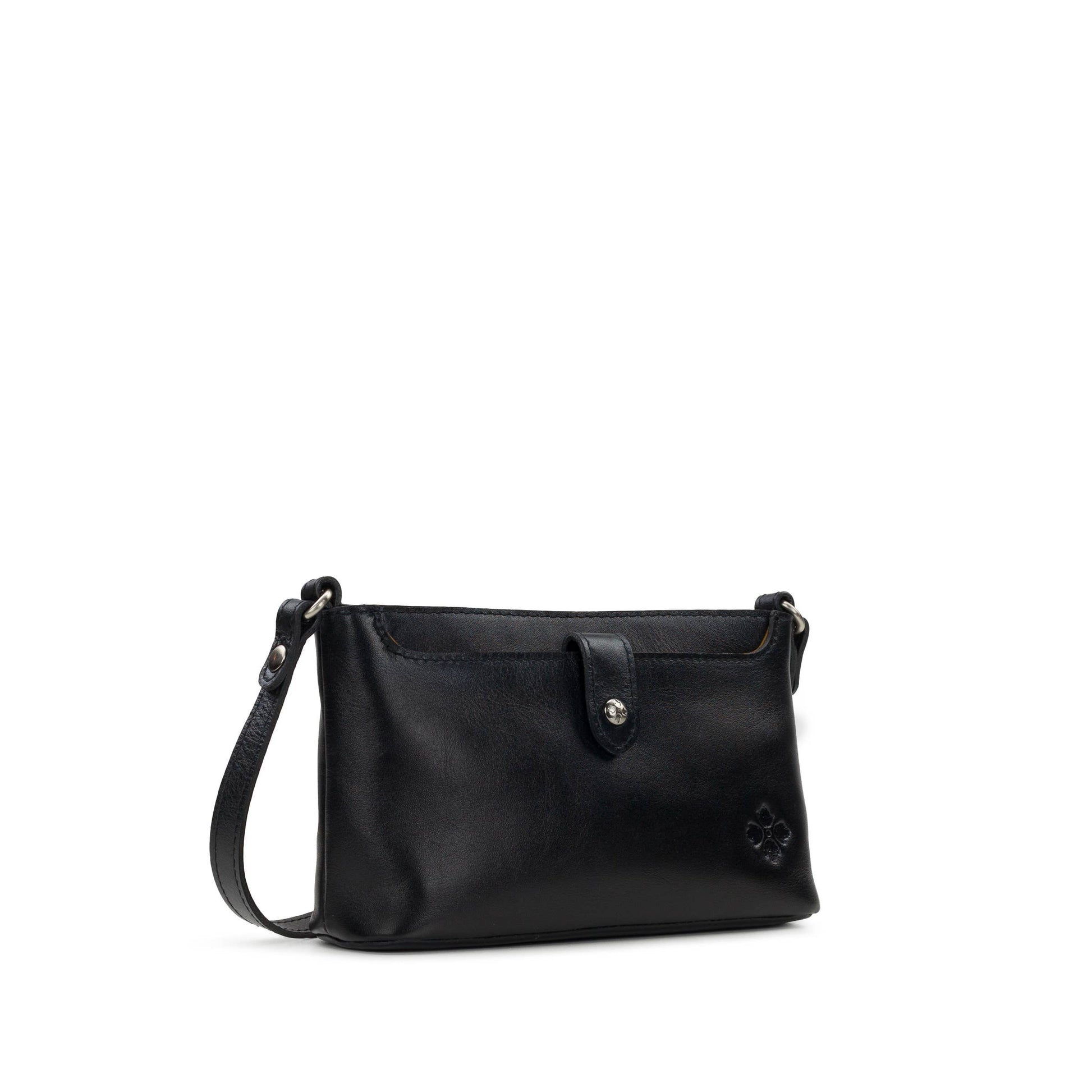 Black Patricia Nash Aimee Crossbody bag with adjustable strap and textured leather finish, shown on a plain background.