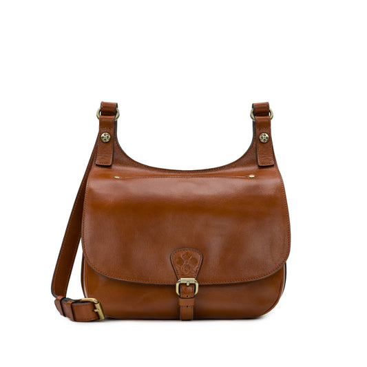 Patricia Nash London Saddle Bag in heritage tan leather with adjustable strap and classic saddle design.