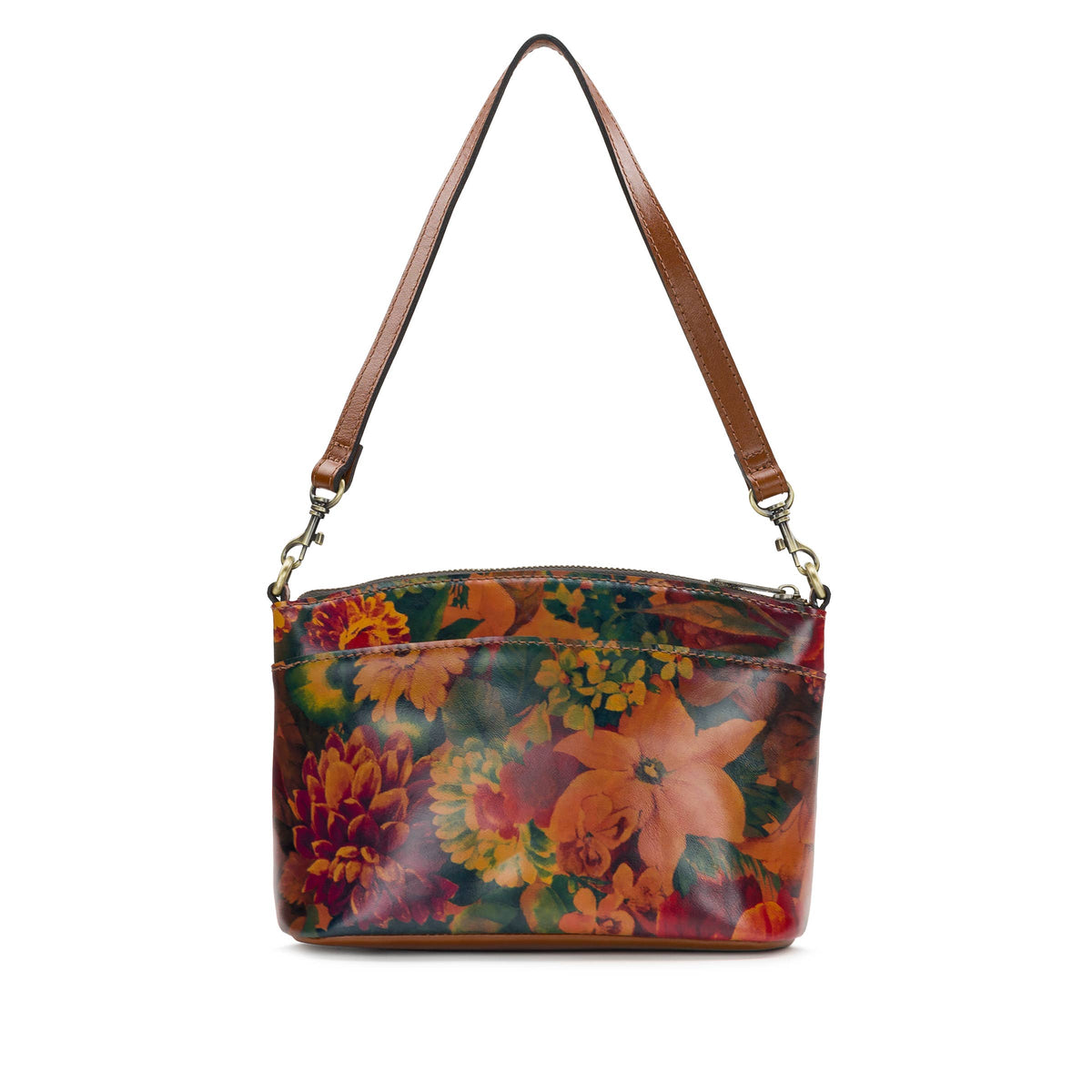 Patricia Nash Arlee Crossbody bag with adjustable strap, brown leather and detailed stitching, resting on a wooden surface.