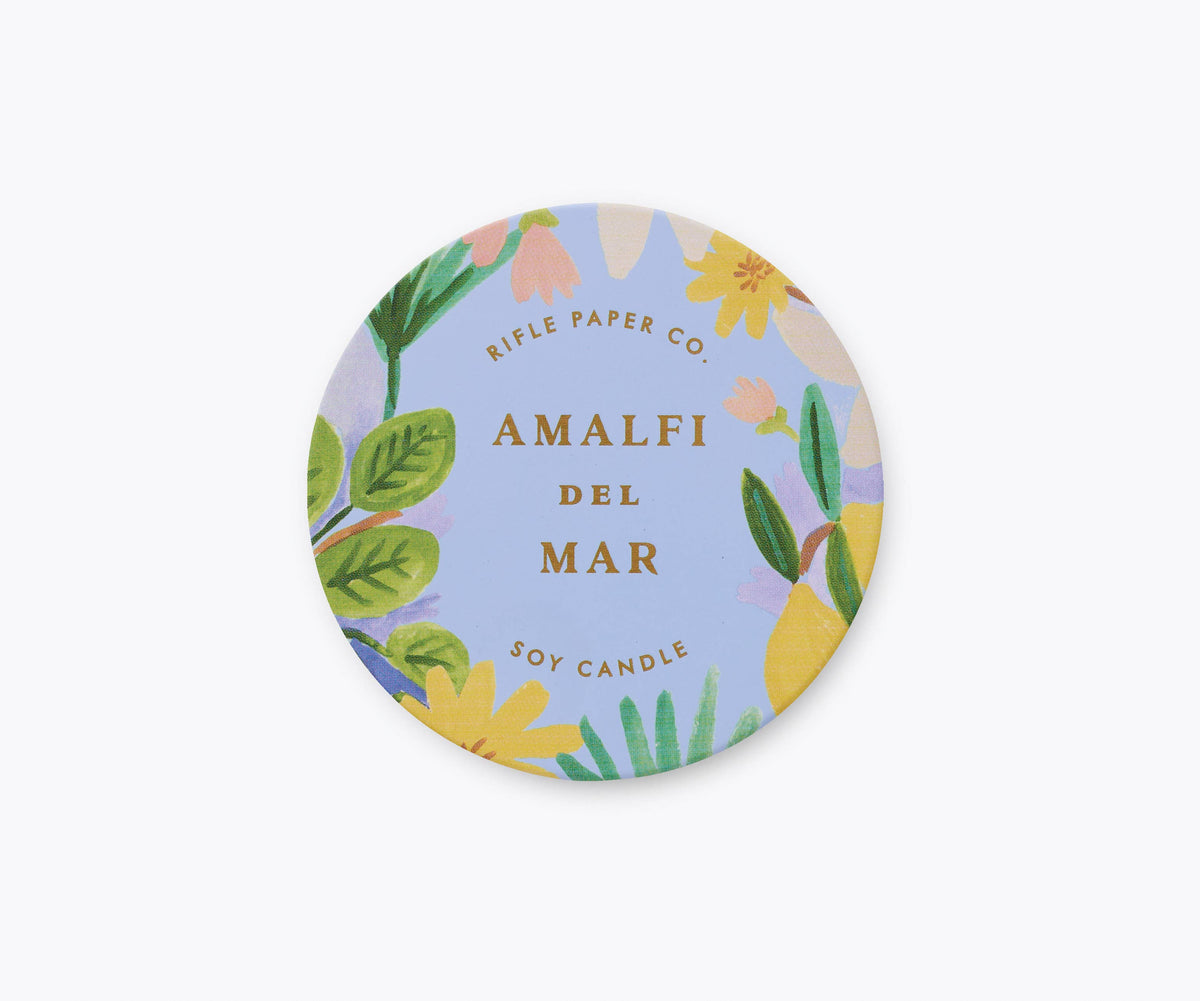 Rifle Paper Company Amalfi del Mar 3 oz tin candle with floral design and white wax inside.