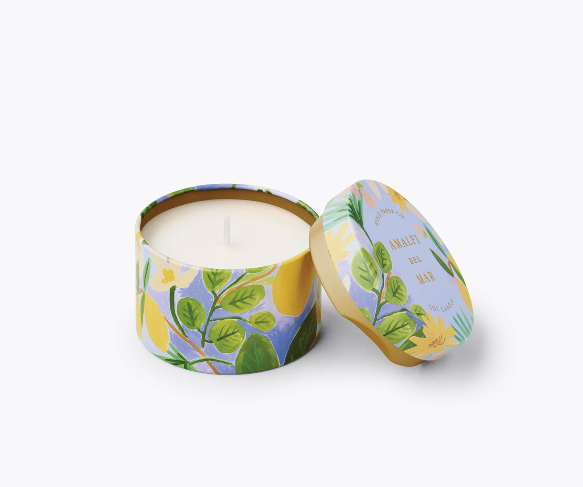 Rifle Paper Company Amalfi del Mar 3 oz tin candle with a colorful floral design and white wax interior.