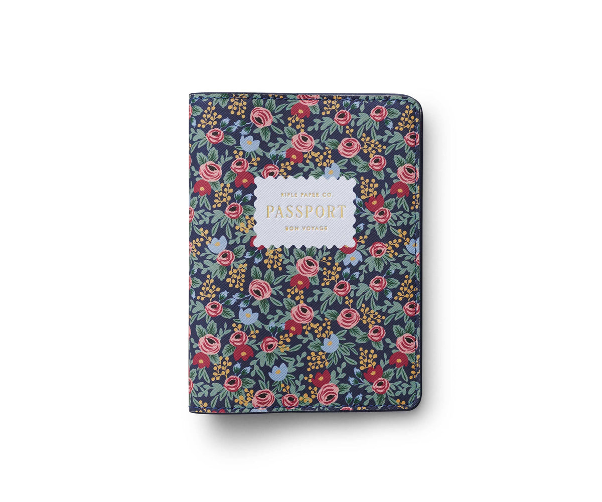 Rifle Paper Company Rosa passport holder with pink floral design and leather interior, ideal for travel accessories.
