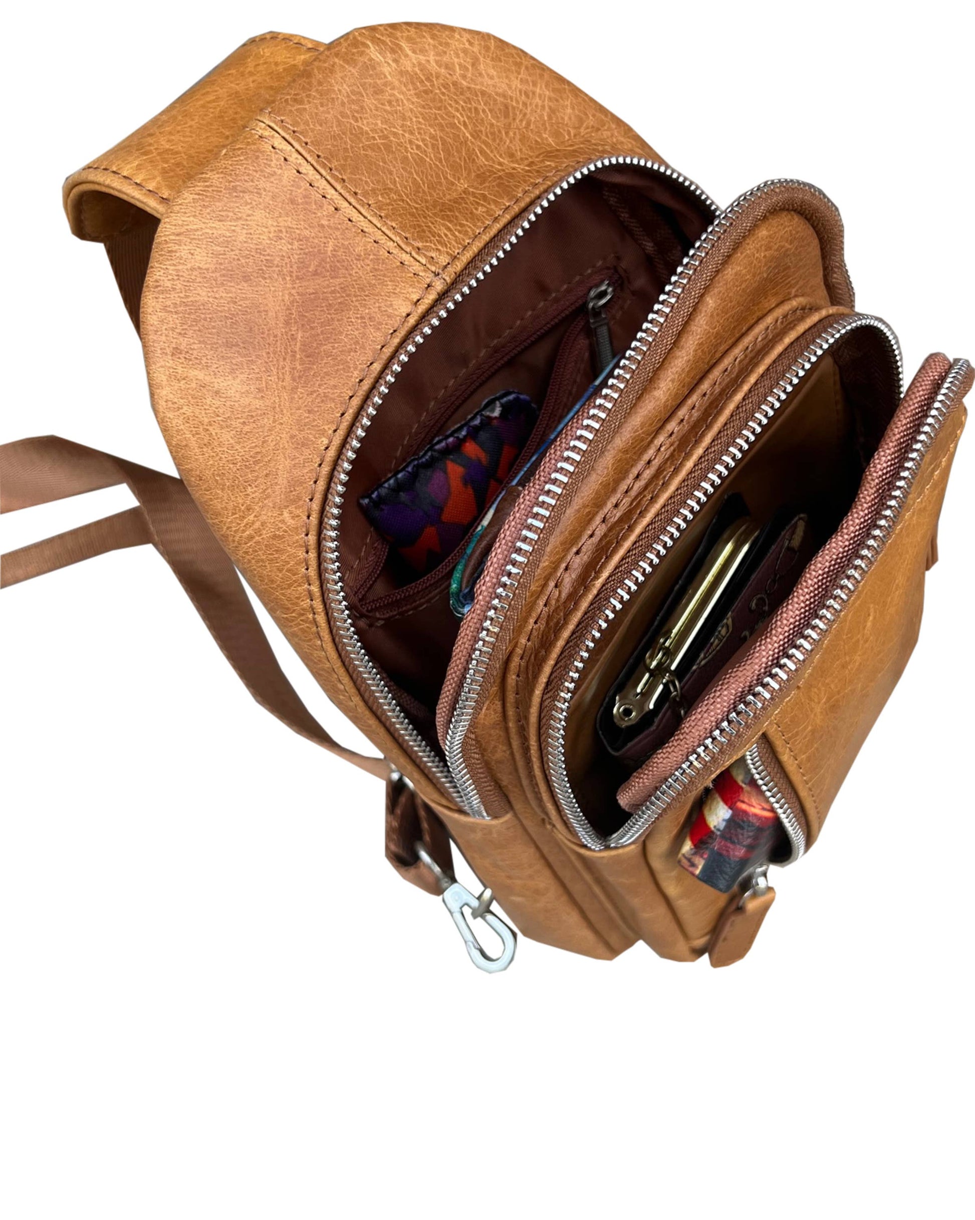 Cowhide leather sling bag with adjustable shoulder strap by Roma Leathers, Inc., featuring a stylish and durable design.