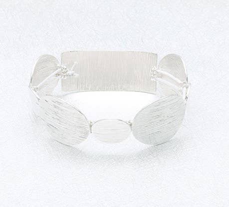 Silver filigree stretch bangle bracelet by S&A Fashions with intricate openwork design and smooth, flexible fit for stylish wear.