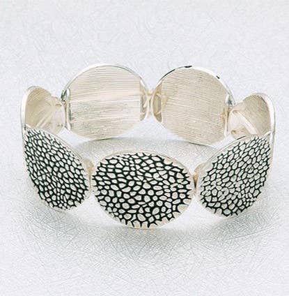 Wide disc stretch bangle in antiqued silver plating with textured surface, stylish jewelry accessory.