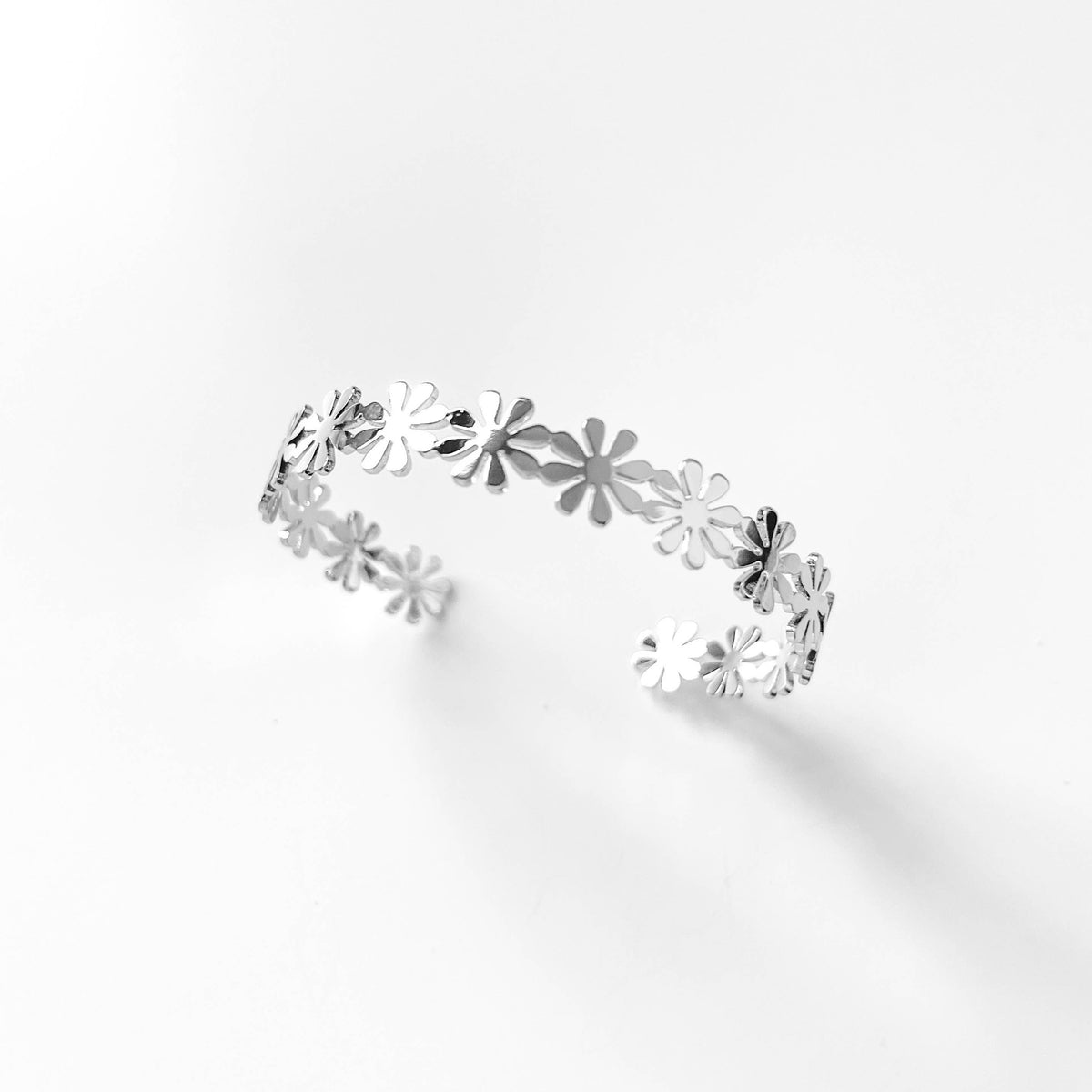 Fashion Daisy Cuff Bracelet by S & A Fashions featuring a delicate floral design on a sleek metal cuff.