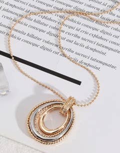 Long multi-layer oblong necklace from S & A Fashions featuring layered geometric pendant designs