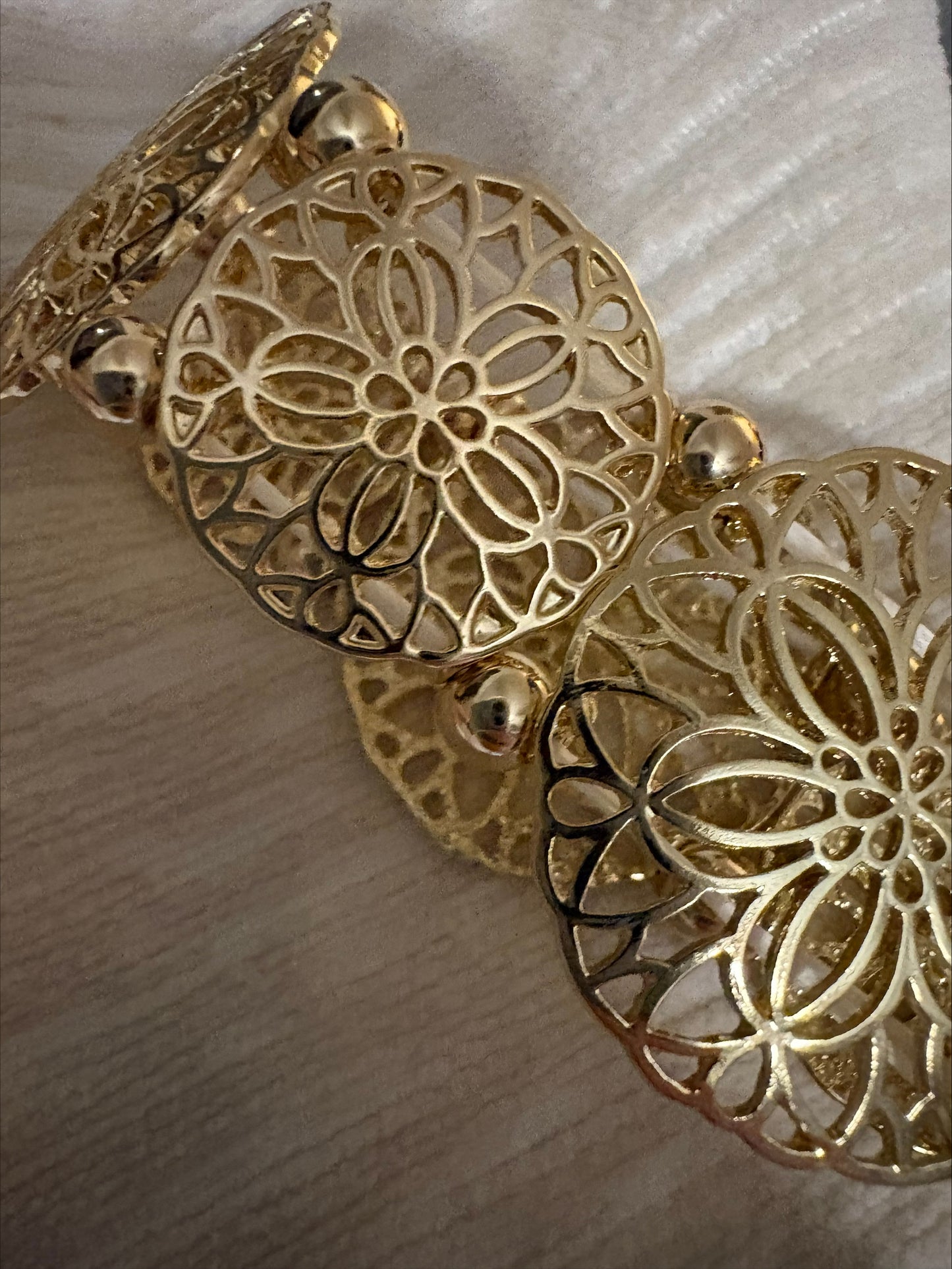 Gold filigree stretch bangle bracelet by S&A Fashions featuring intricate openwork design.
