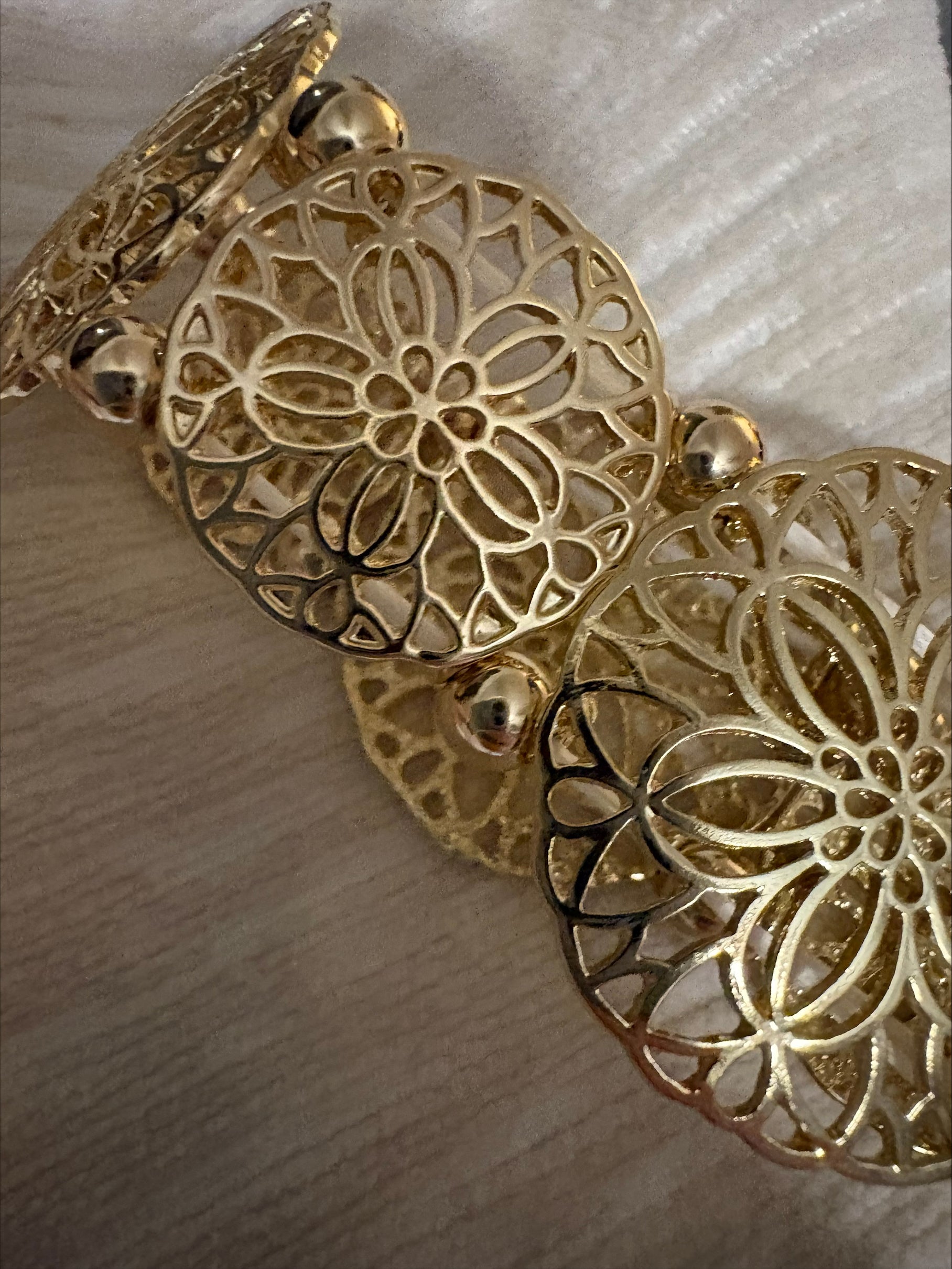 Gold filigree stretch bangle bracelet by S&A Fashions featuring intricate openwork design.