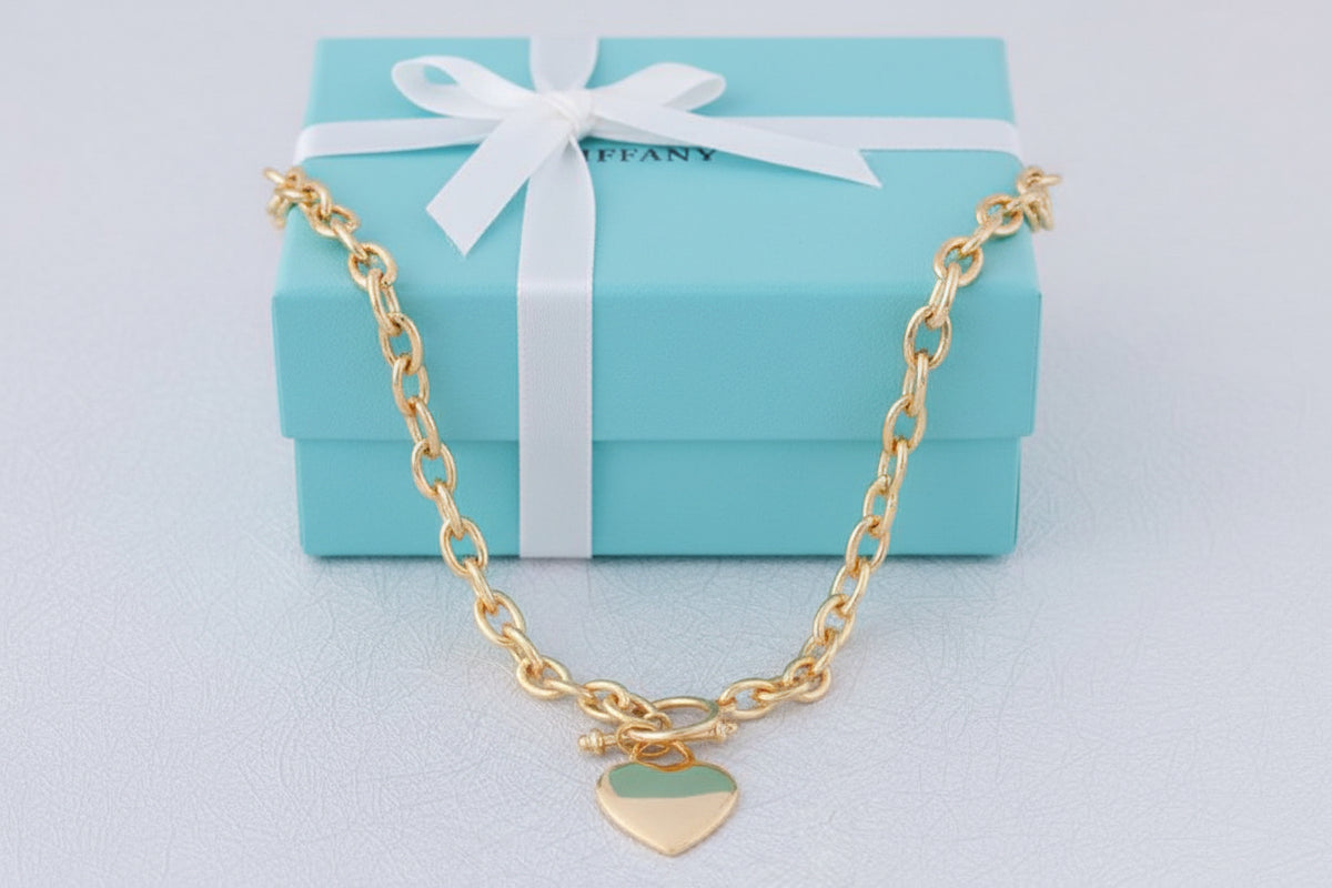 Gold Tiffany 18-inch Heart Tag Necklace by S & A Fashions, featuring a delicate heart-shaped pendant on a fine chain.