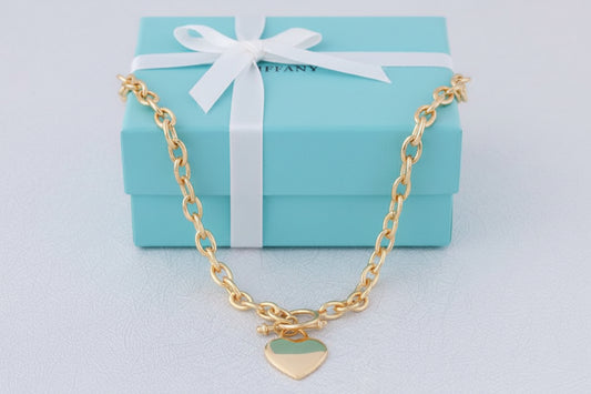Gold Tiffany 18-inch Heart Tag Necklace by S & A Fashions, featuring a delicate heart-shaped pendant on a fine chain.