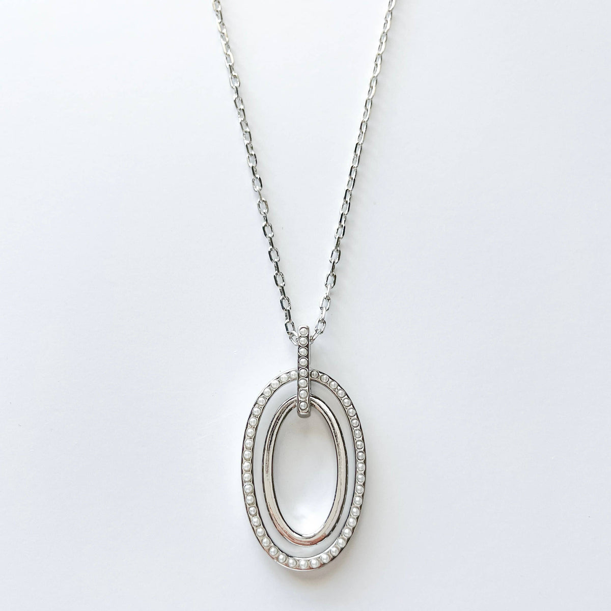 S & A Fashions double oval pendant necklace with mini faux pearls, featuring a stylish and elegant jewelry design.