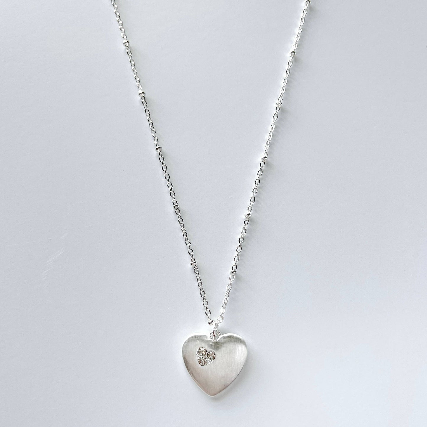 S & A Fashions heart-shaped stone pendant necklace with a delicate chain, perfect for stylish jewelry accessories.