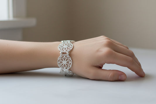 Silver filigree stretch bangle bracelet by S&A Fashions with intricate openwork design and elegant craftsmanship.