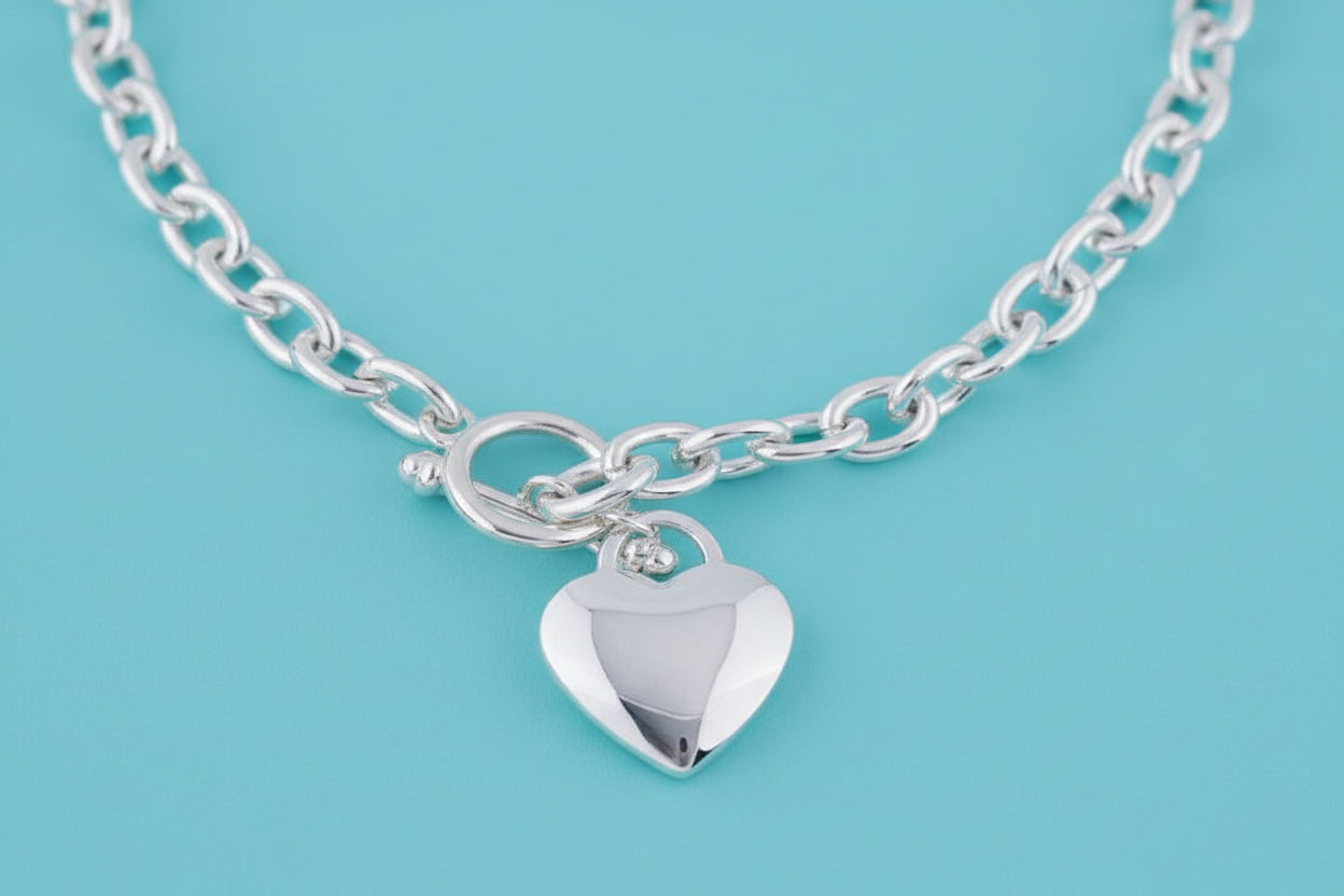 Silver Tiffany 18-inch Heart Tag Necklace by S & A Fashions featuring a polished heart-shaped pendant on a delicate chain.