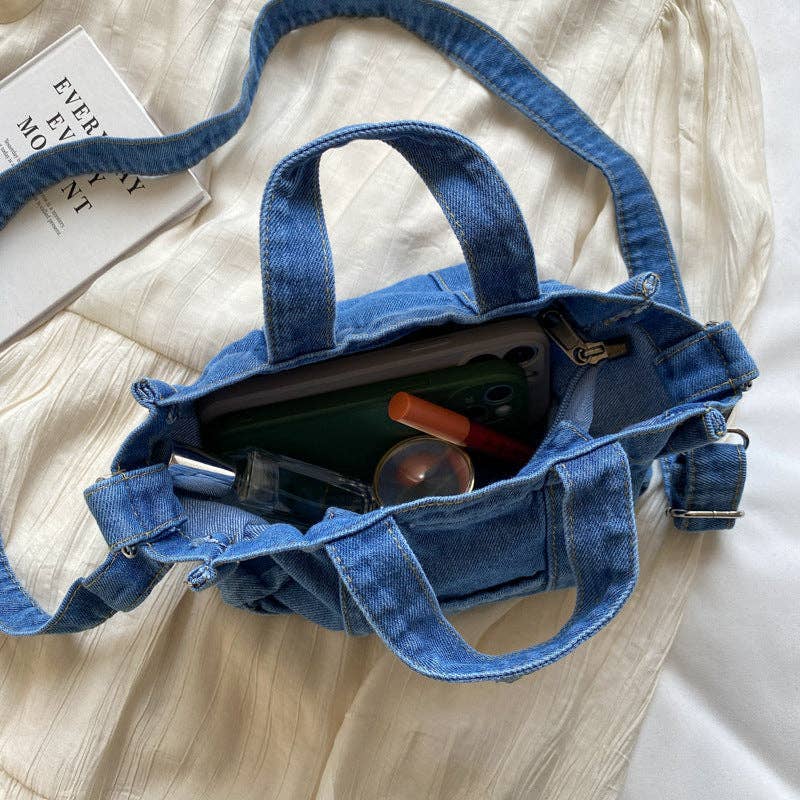 Denim handbag by SALINA TRADING INC featuring a stylish, casual design with handles and visible stitching.