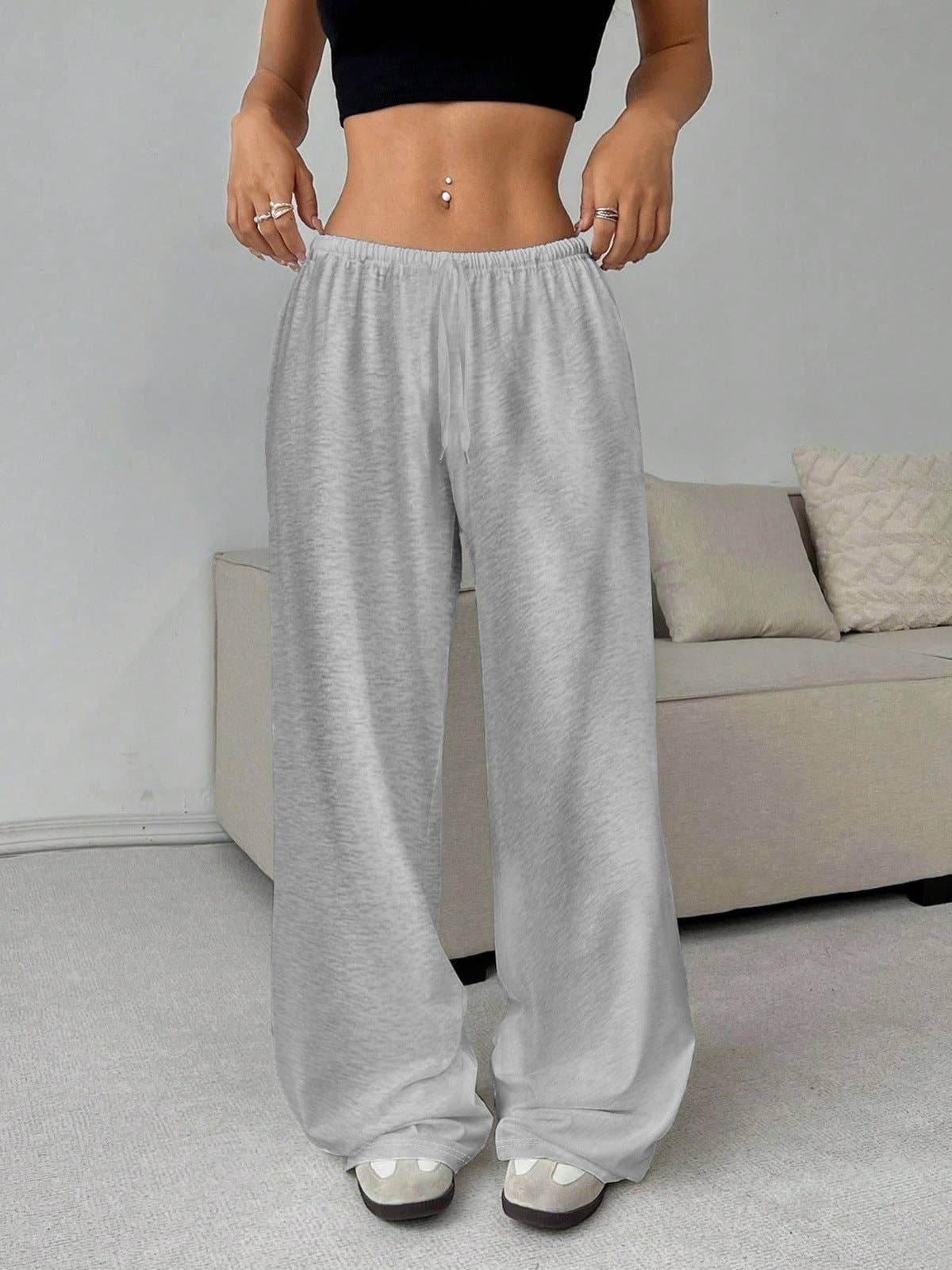Loose wide leg pants by SALINA TRADING INC displayed on a hanger, featuring flowy fabric and a relaxed fit.