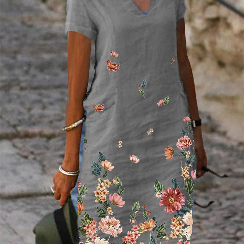 Floral printed short-sleeve V-neck dress by SALINA TRADING INC featuring a vibrant floral pattern and a relaxed fit.