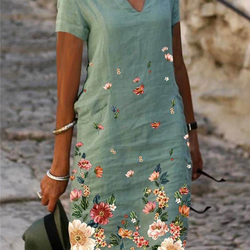 Floral printed short-sleeve V-neck dress from SALINA TRADING INC featuring a vibrant flower pattern and lightweight fabric.