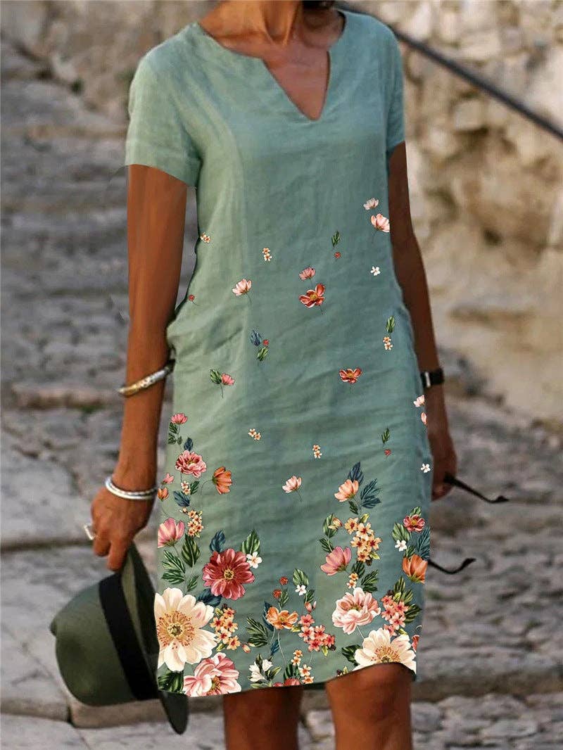 Floral printed short-sleeve V-neck dress by SALINA TRADING INC featuring a vibrant floral pattern and lightweight fabric.