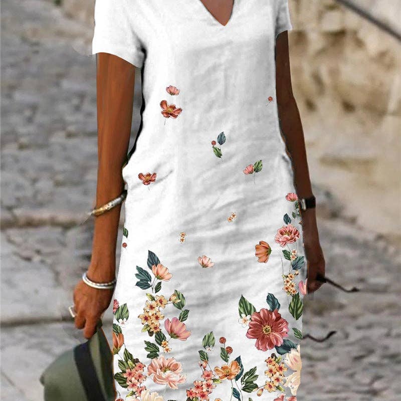 Floral printed short-sleeve V-neck dress by SALINA TRADING INC featuring vibrant flower patterns and a relaxed fit.