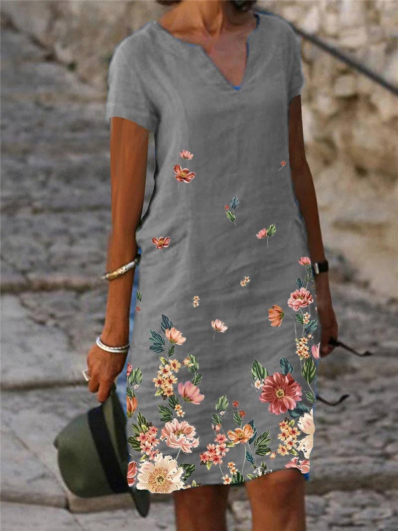 Floral printed V-neck dress by SALINA TRADING INC featuring a lightweight fabric and colorful floral pattern.