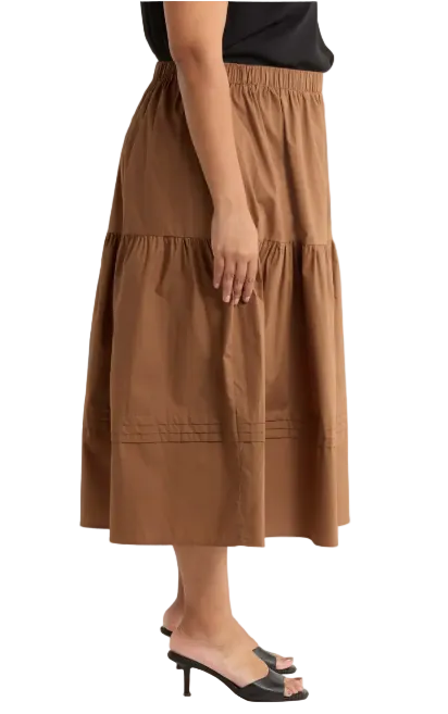 Sugarl!ps brown pleated midi skirt shown from the side, featuring a flowy, pleated design perfect for casual or formal wear.