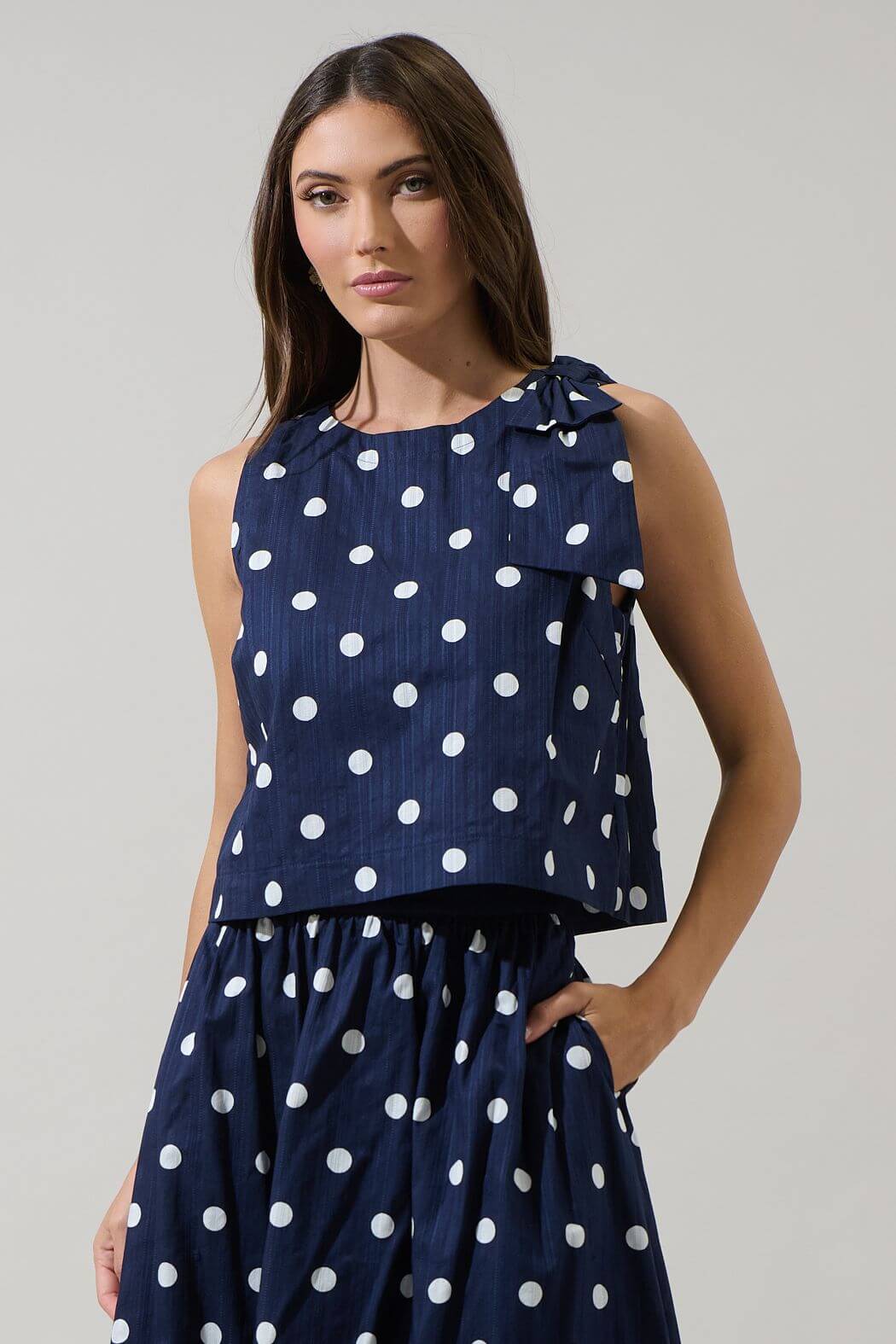 Sugarl!ps Caryn polka dot sleeveless top with ruffled neckline and lightweight fabric, stylish and perfect for summer wear.