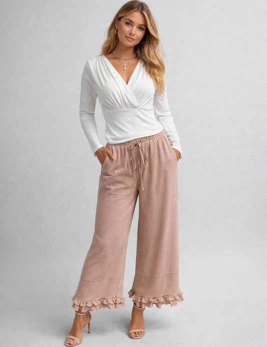 Sweetkama ladies wide-leg pants with elastic waist, drawstring, and ruffle hem, showcasing relaxed fit and stylish design.