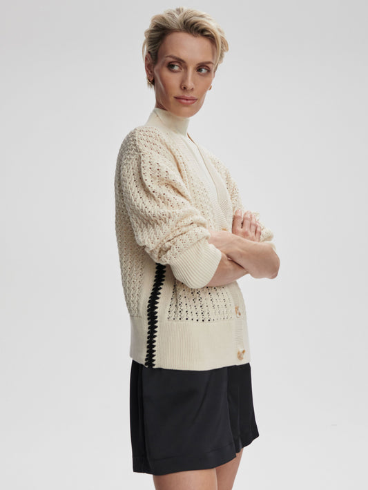 A Varley Astell relaxed knit cardigan in birch color, shown draped on a model with a cozy, casual fit.