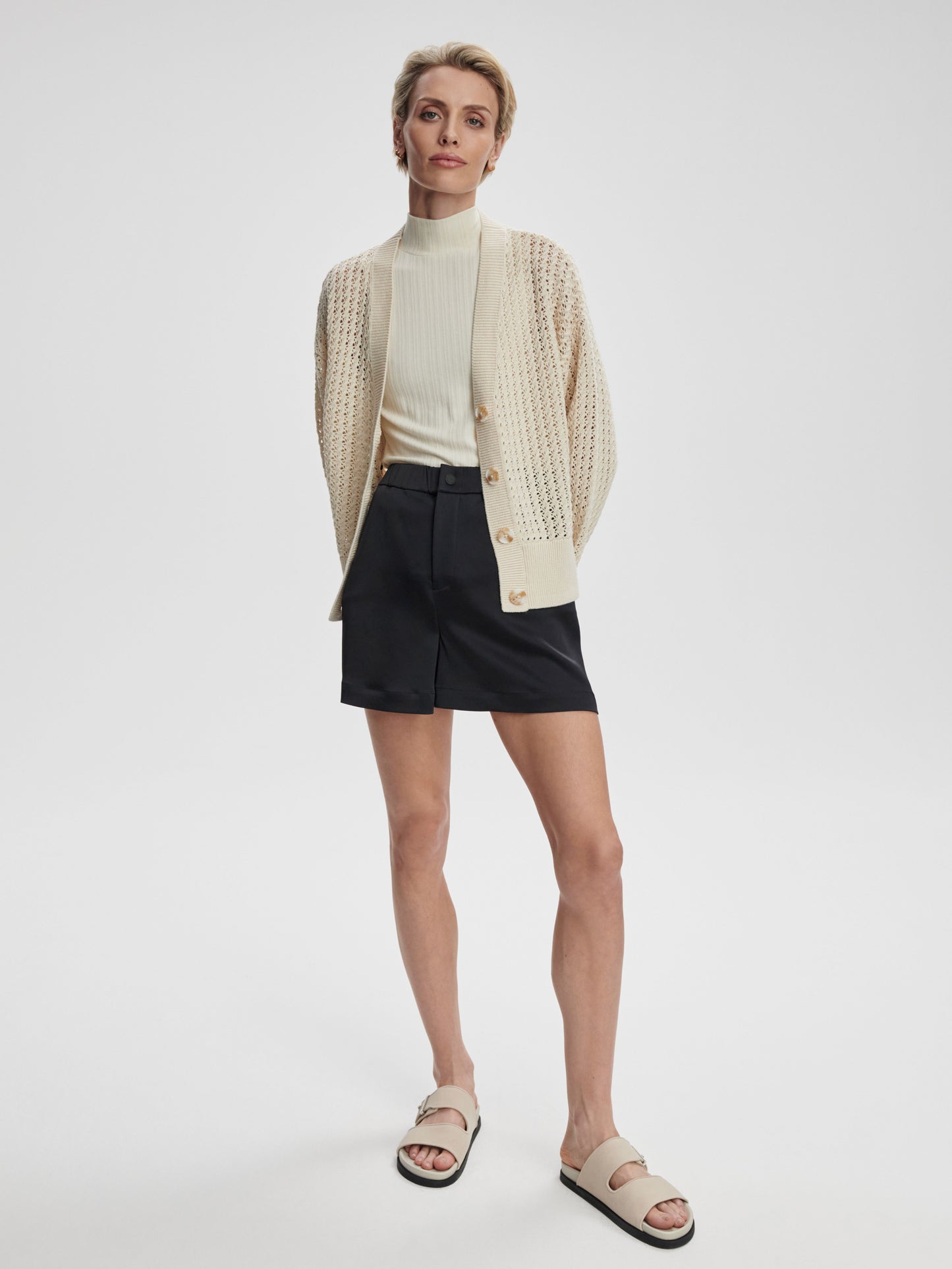 Astell relaxed knit cardigan by Varley in birch color, featuring a cozy, soft fabric with a relaxed fit and open front.