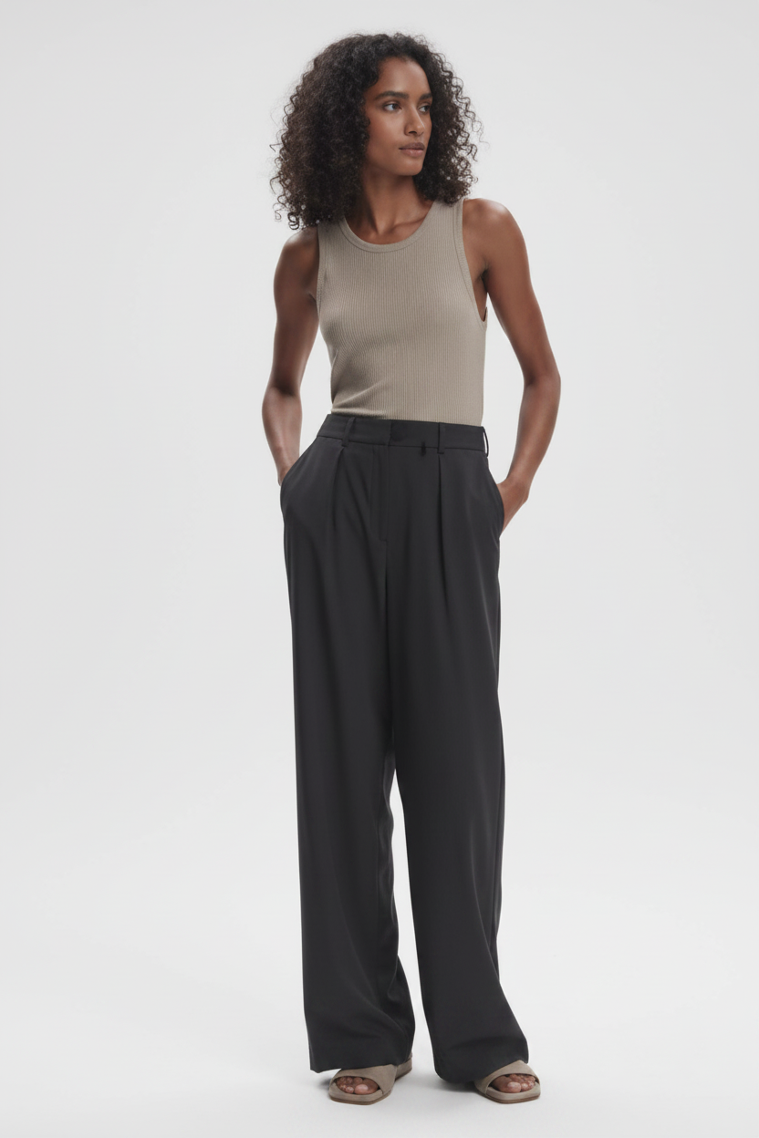 Varley Kayson wide-leg trousers in neutral fabric, featuring a relaxed fit and high waist, displayed on a hanger.